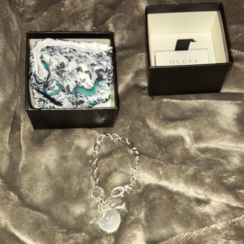 Gucci sterling silver icon charm bracelet.. new in box.. never worn. Italy made.